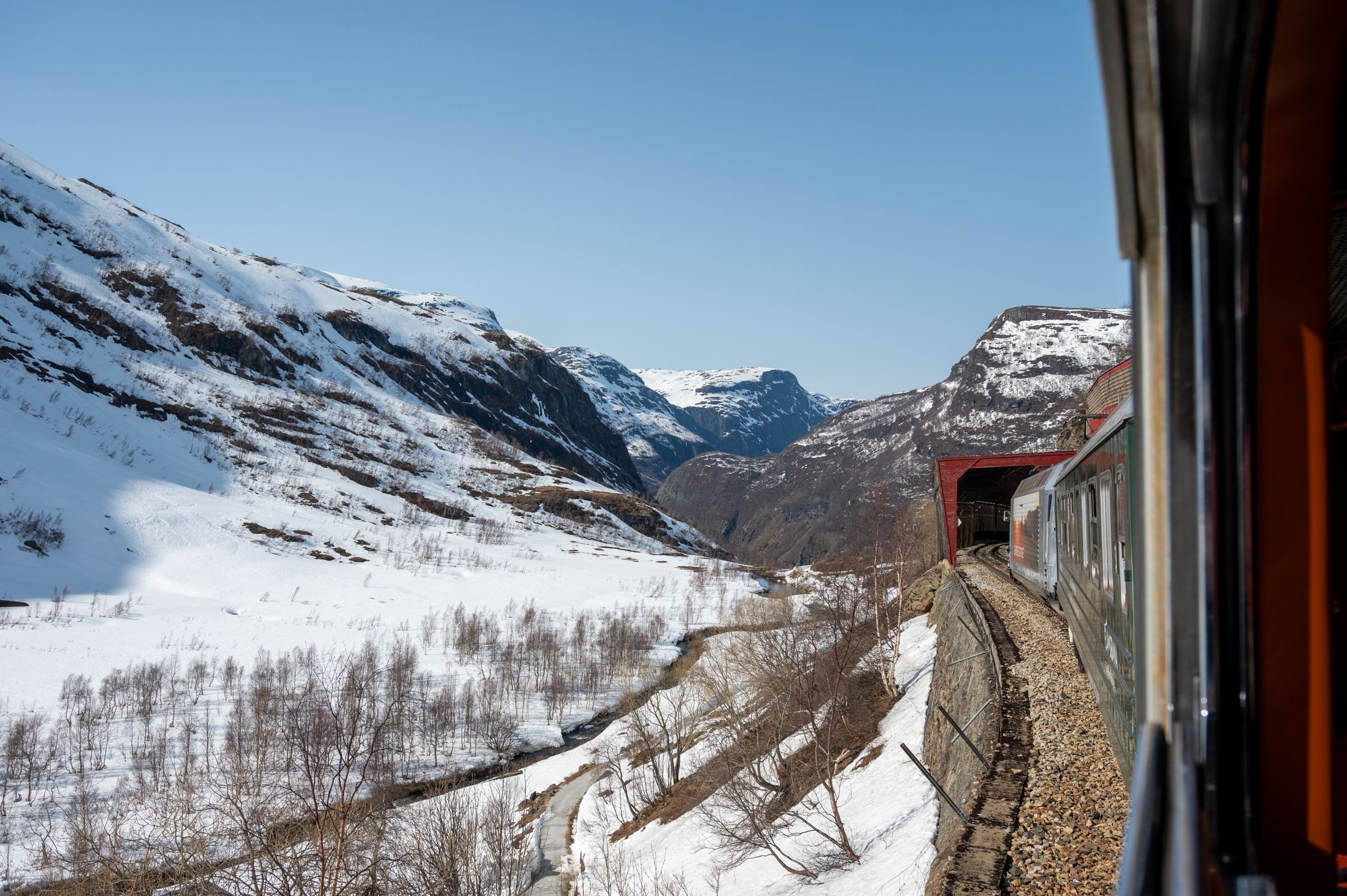 A train window view of Norway's snowy mountains