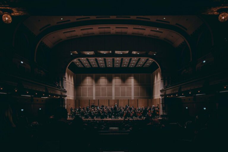 An orchestra performing in a grand concert hall