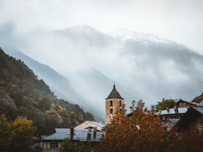 The church tower in Ordino with mountains in the mist, Andorra