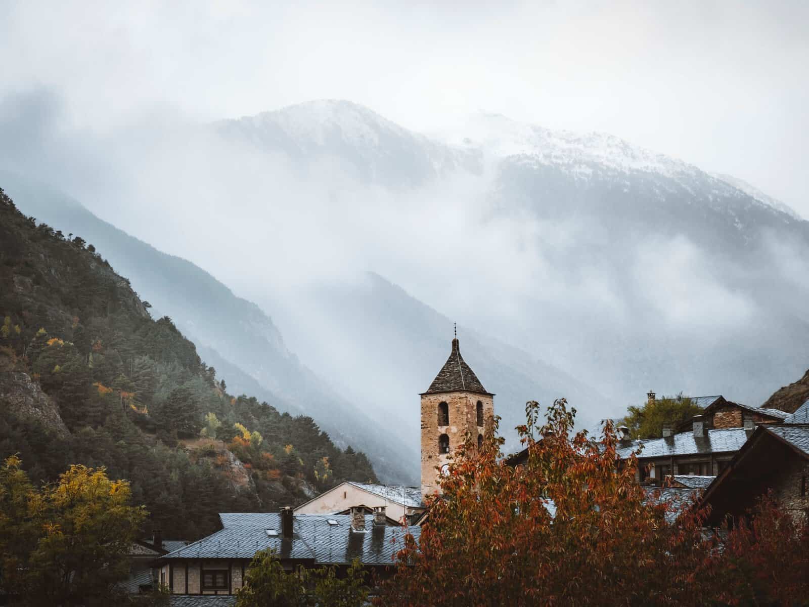 The church tower in Ordino with mountains in the mist, Andorra