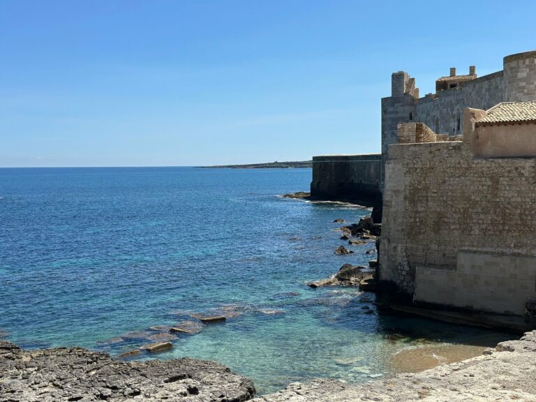 The coast of Ortigia and its stone walls