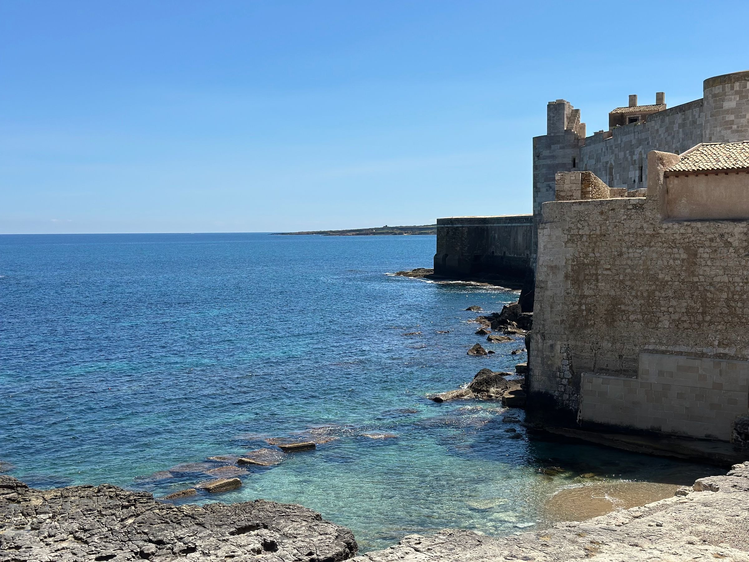 The coast of Ortigia and its stone walls