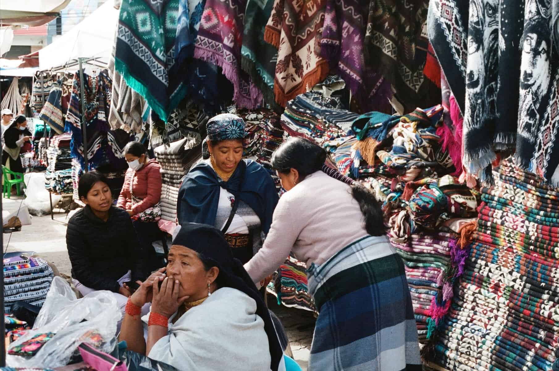Textiles and vendors at Otavalo market, Ecuador