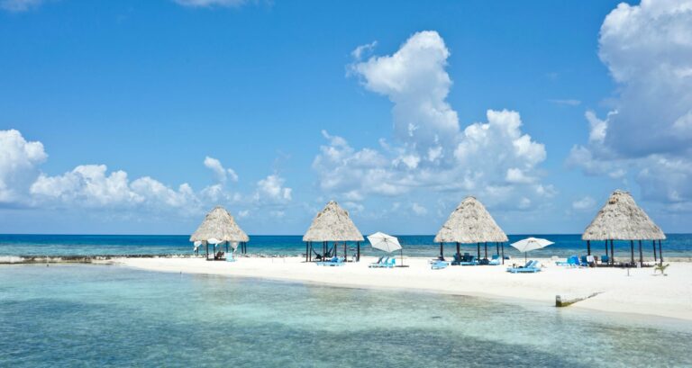 Palapas on a white-sand beach in Belize