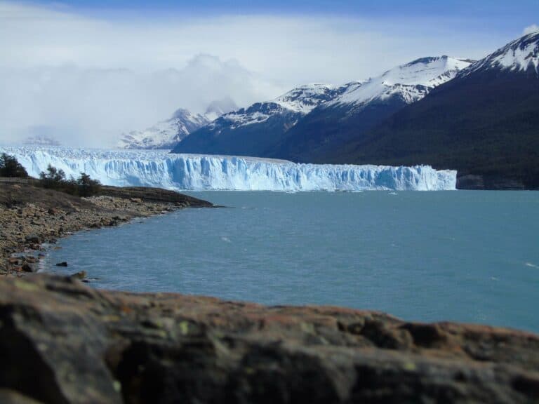 The Perito Moreno Glacier beneath snowy mountains