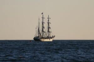 Tall sailing ship under full sail at sea