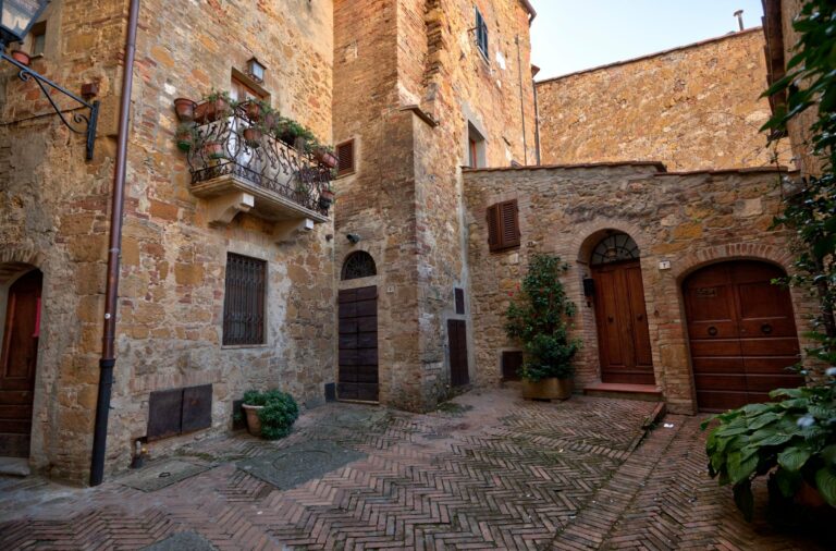 A stone alley with balconies in Pienza
