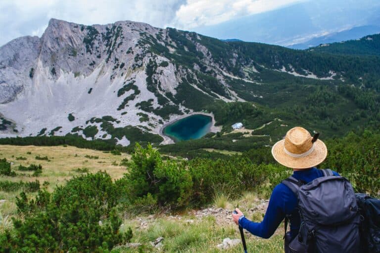 A hiker above a lake in the Pirin Mountains, Bulgaria