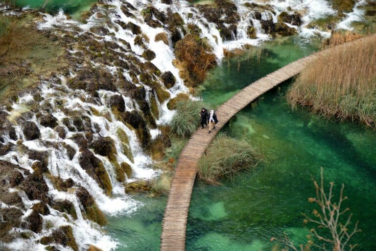 Boardwalk between turquoise pools and waterfalls at Plitvice Lakes, Croatia