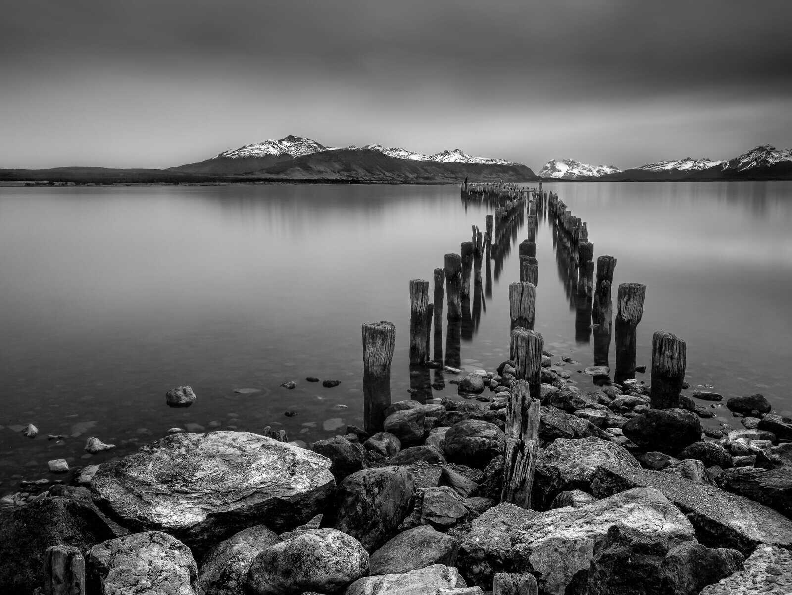 Old wooden pier posts at Puerto Natales