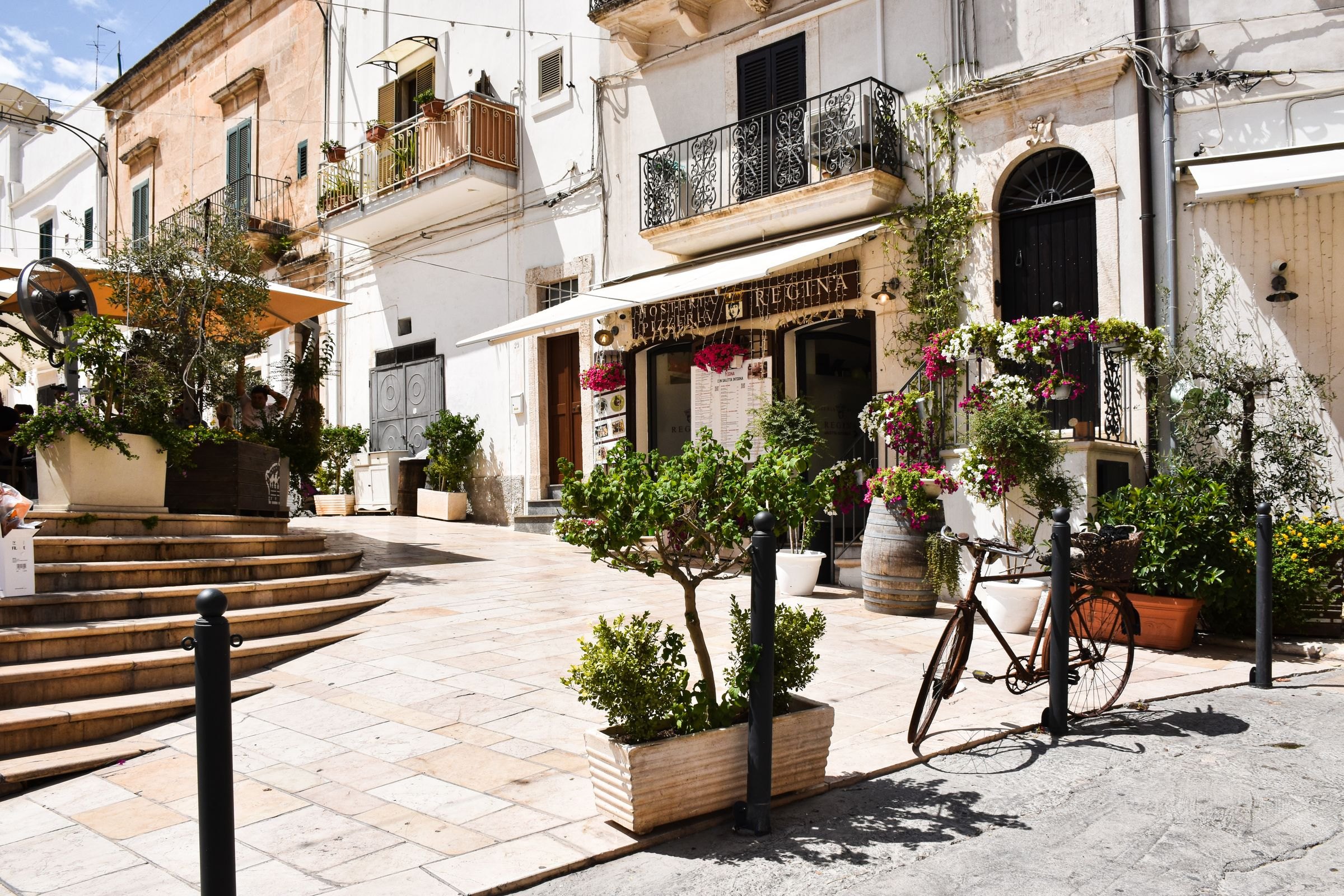 A sunny street in a whitewashed town in Puglia