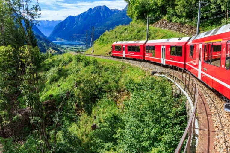The red Bernina Express train curving through the Swiss Alps
