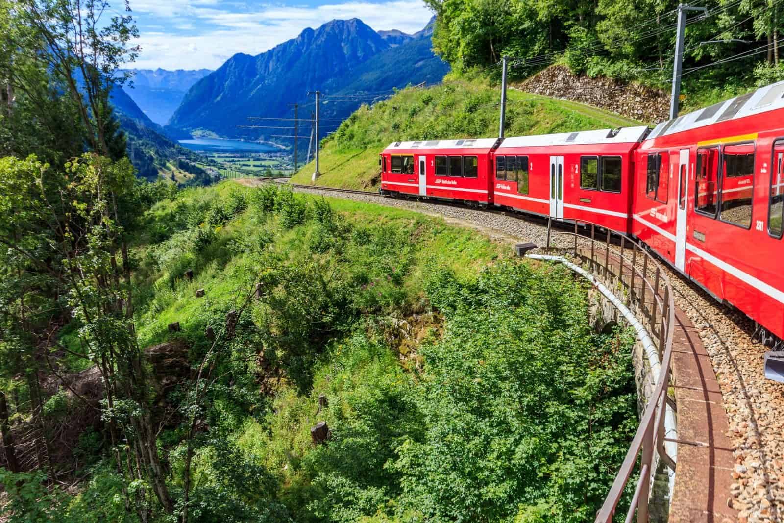 The red Bernina Express train curving through the Swiss Alps
