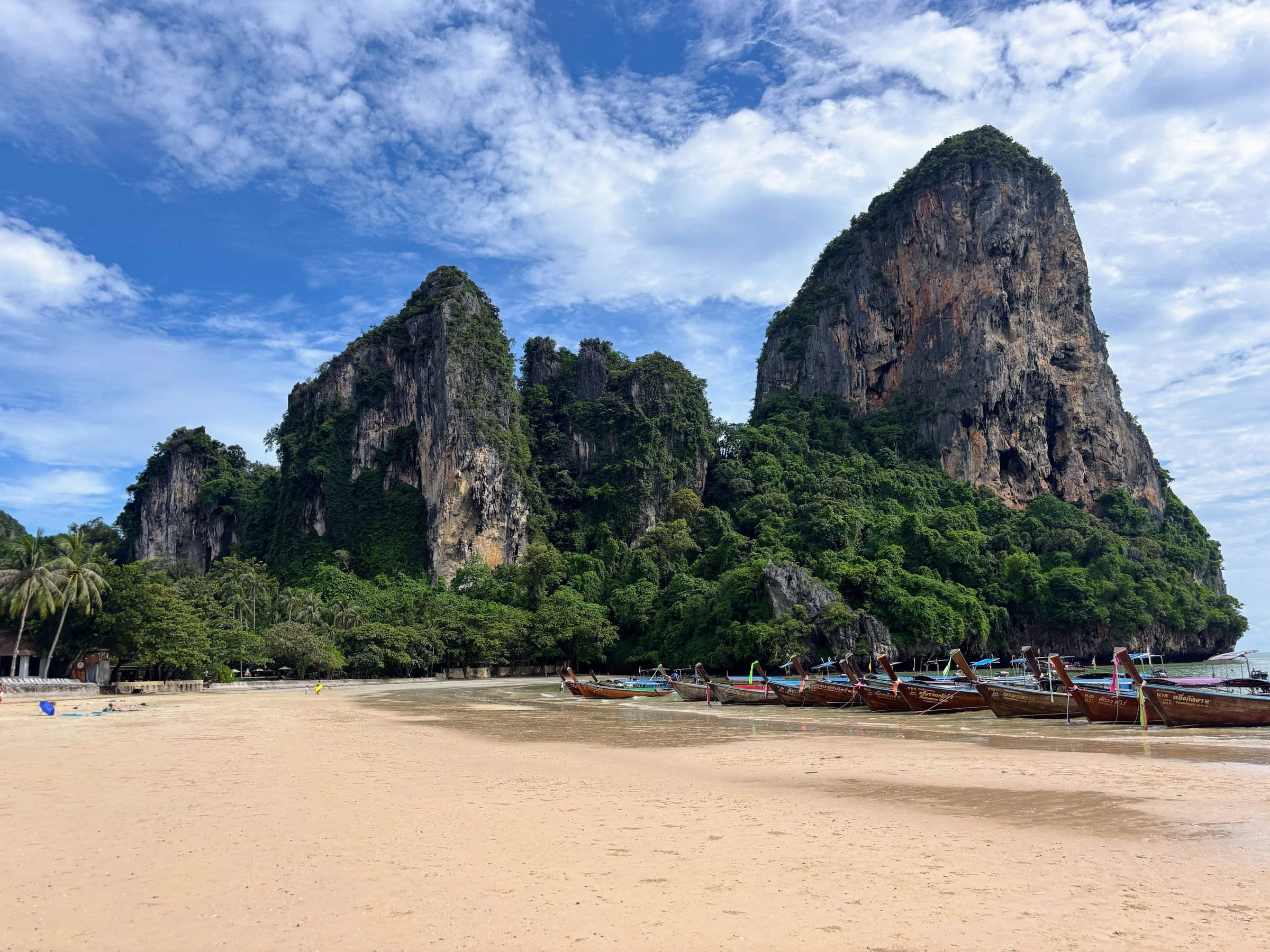 Longtail boats below the cliffs of Railay Beach, Krabi