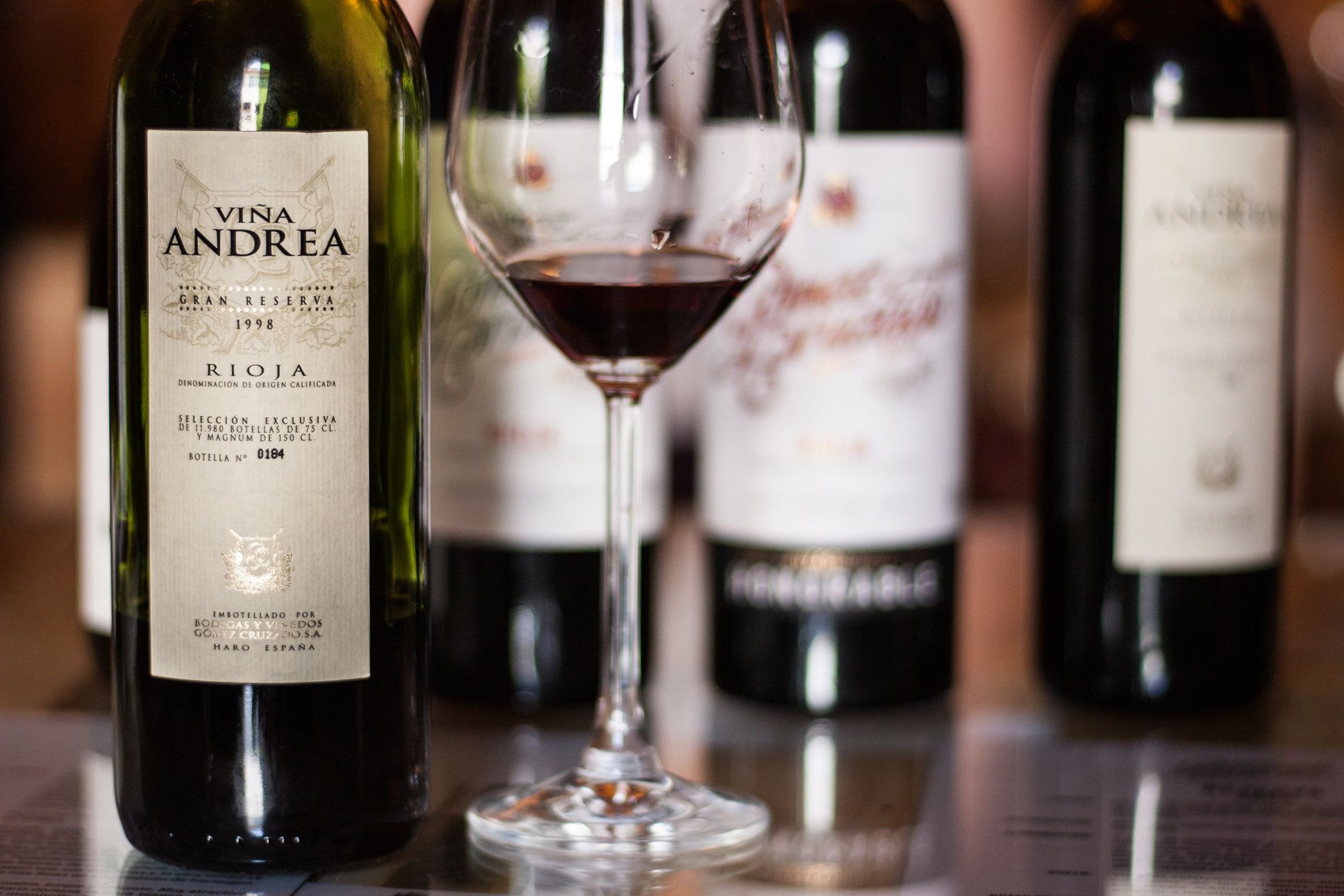 Rioja wine bottles and a glass