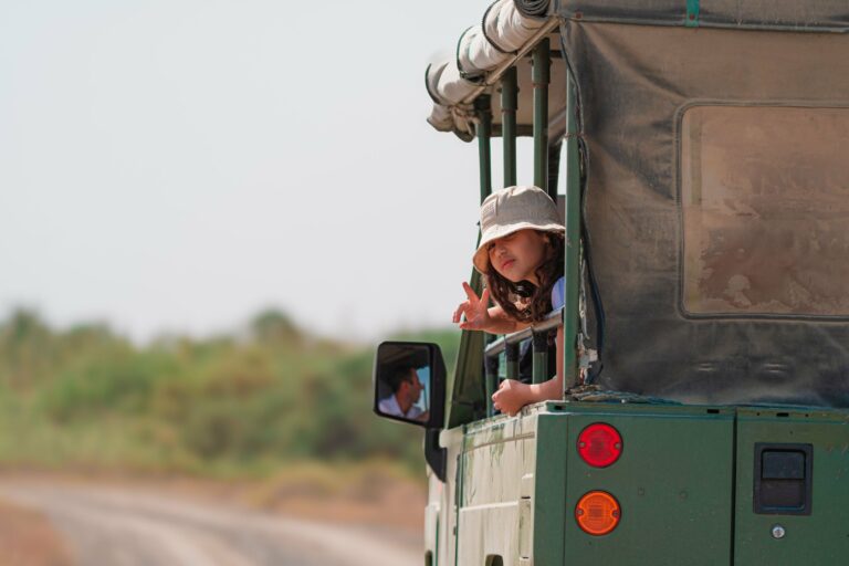 A girl looking out from an open safari vehicle