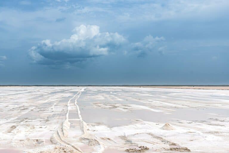 A wide salt flat under a dramatic sky