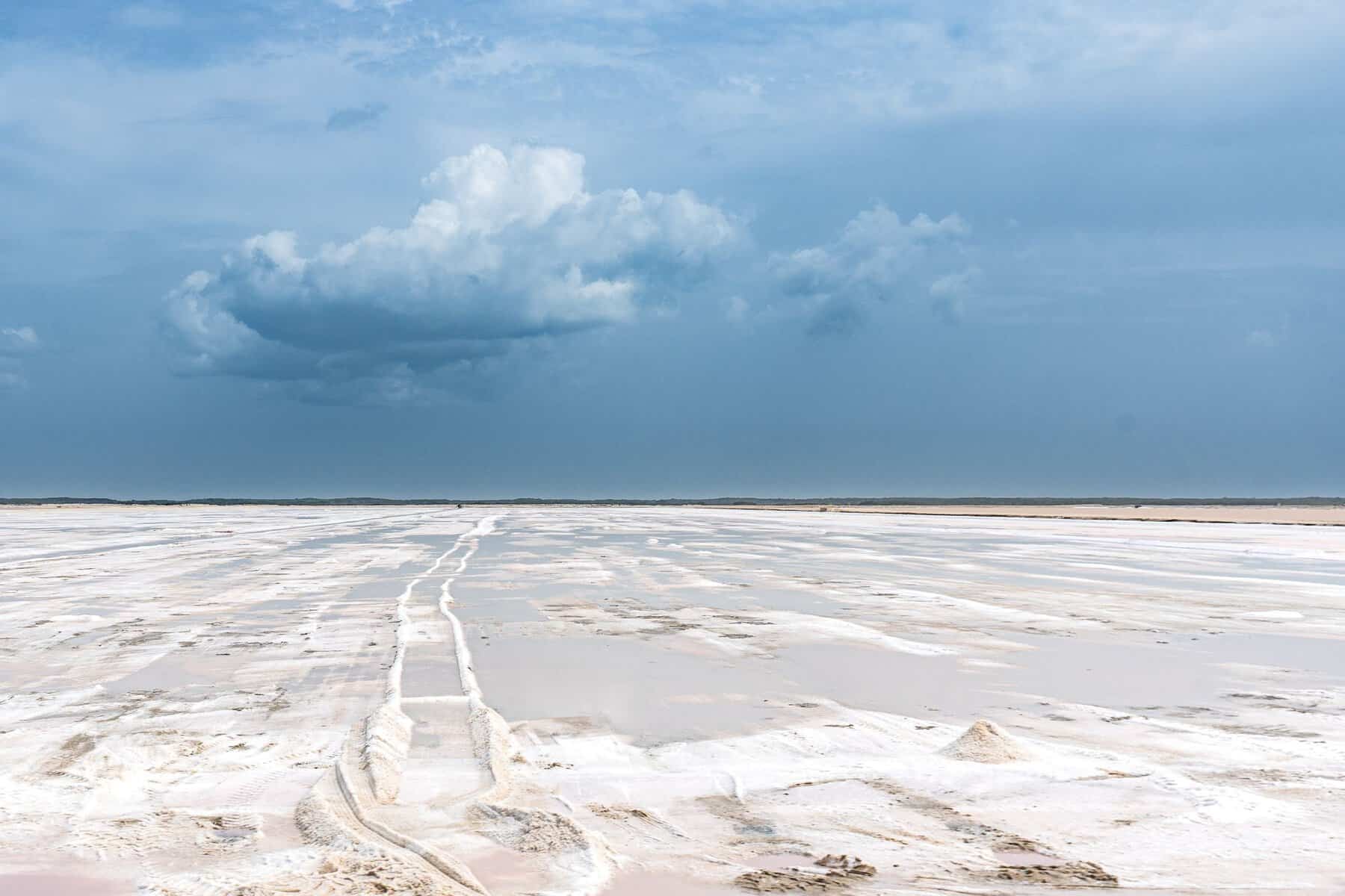 A wide salt flat under a dramatic sky