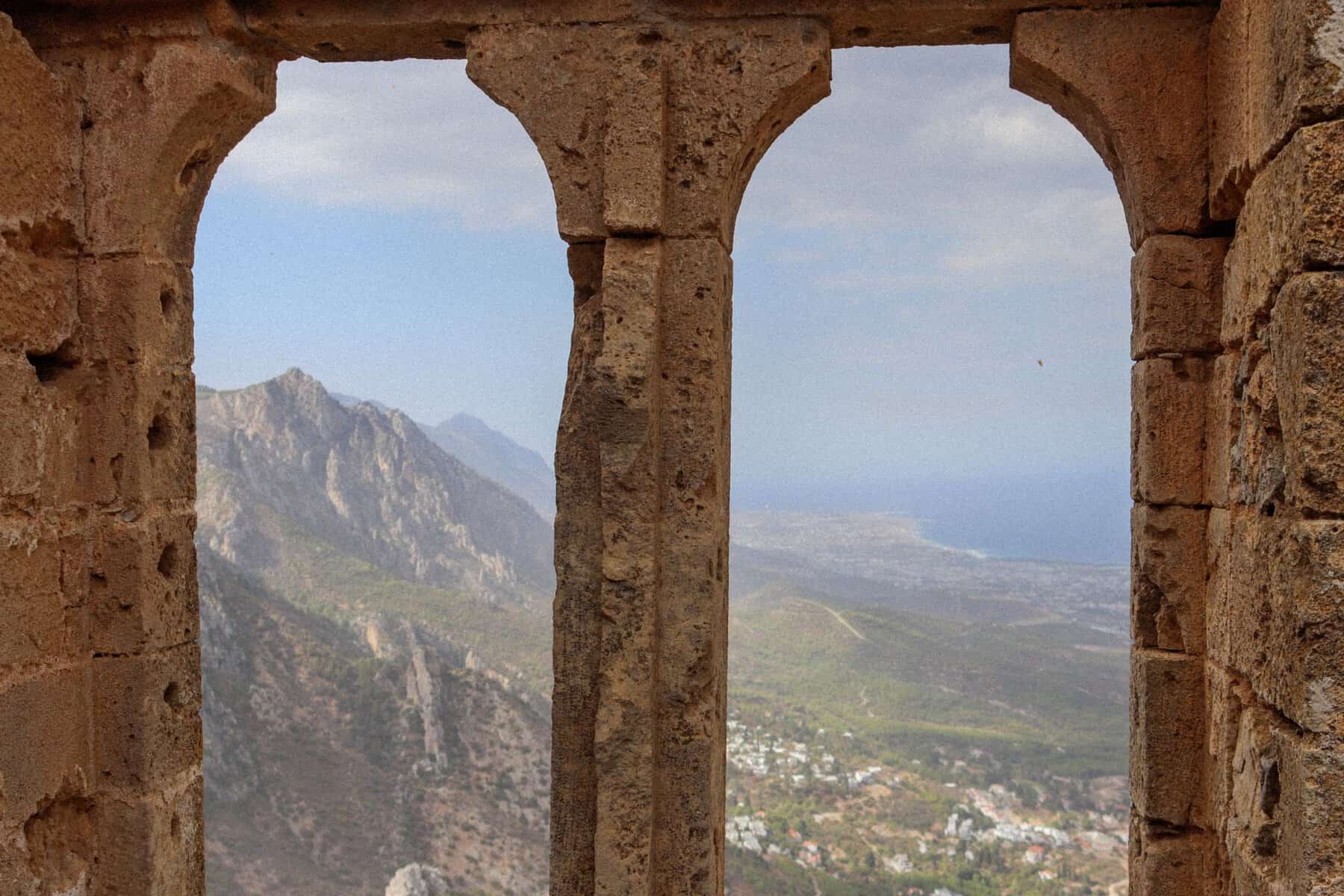 Mountains and coastline seen through the arched windows of St Hilarion Castle, North Cyprus