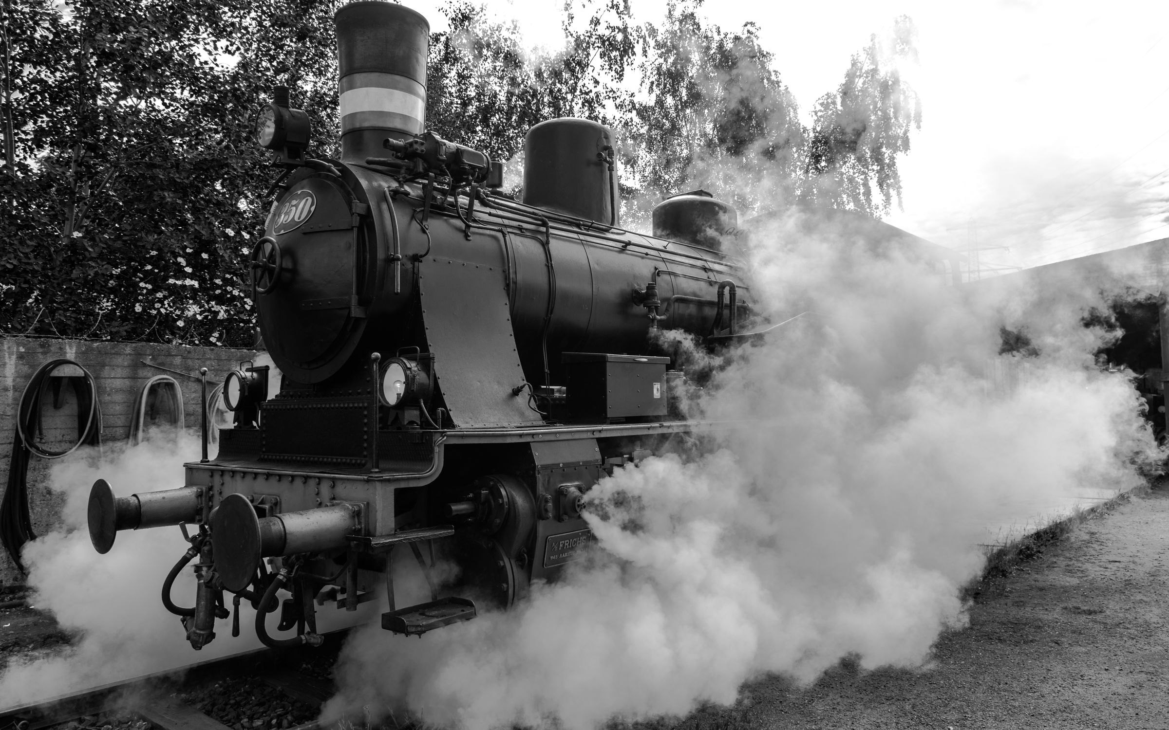 A steam locomotive releasing steam