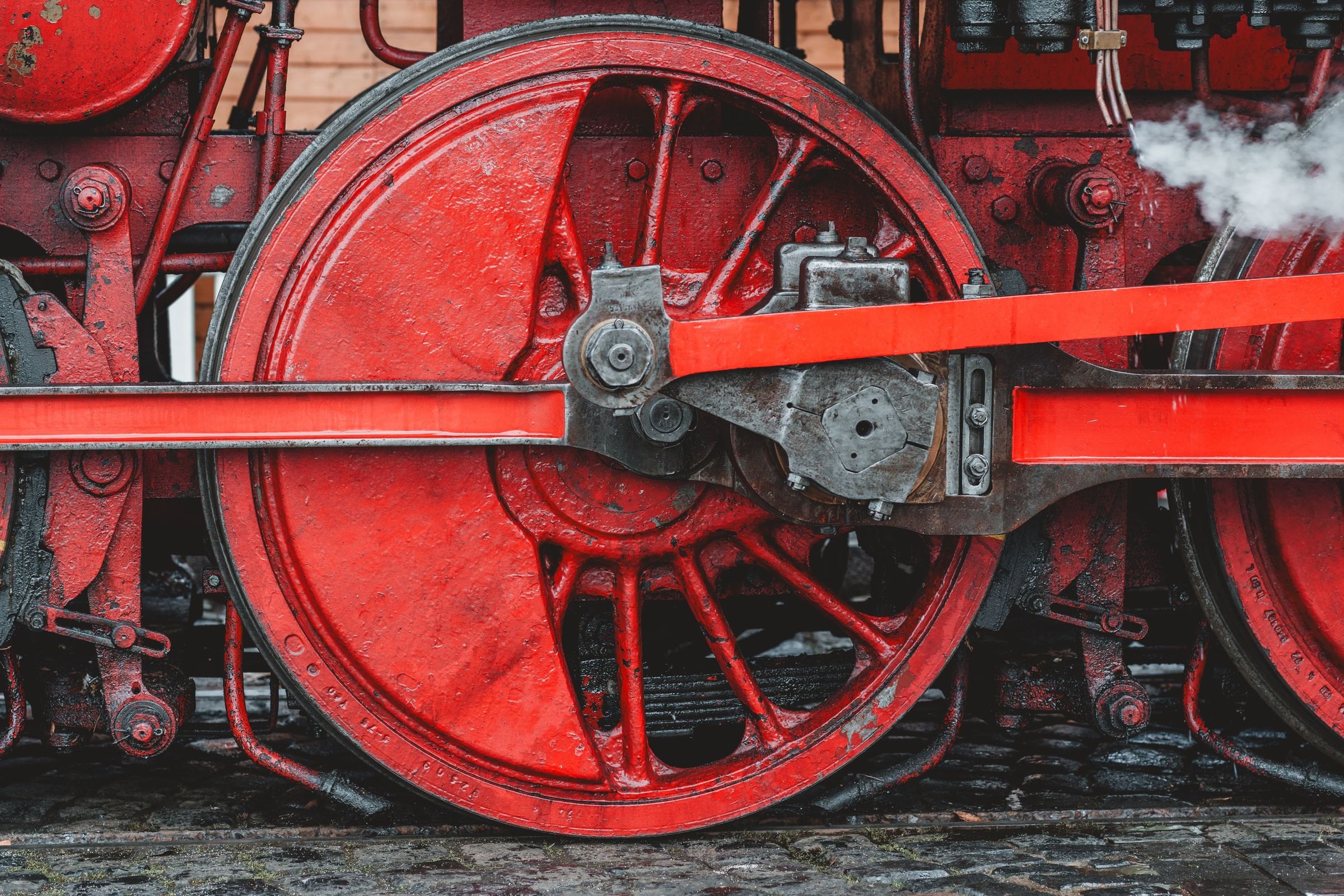 The red wheel of a vintage steam locomotive