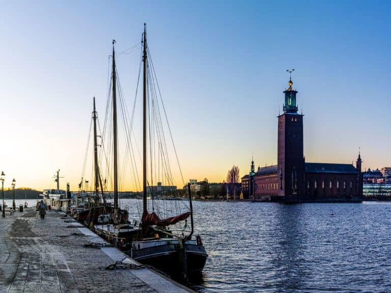 Stockholm City Hall across the water with sailing boats