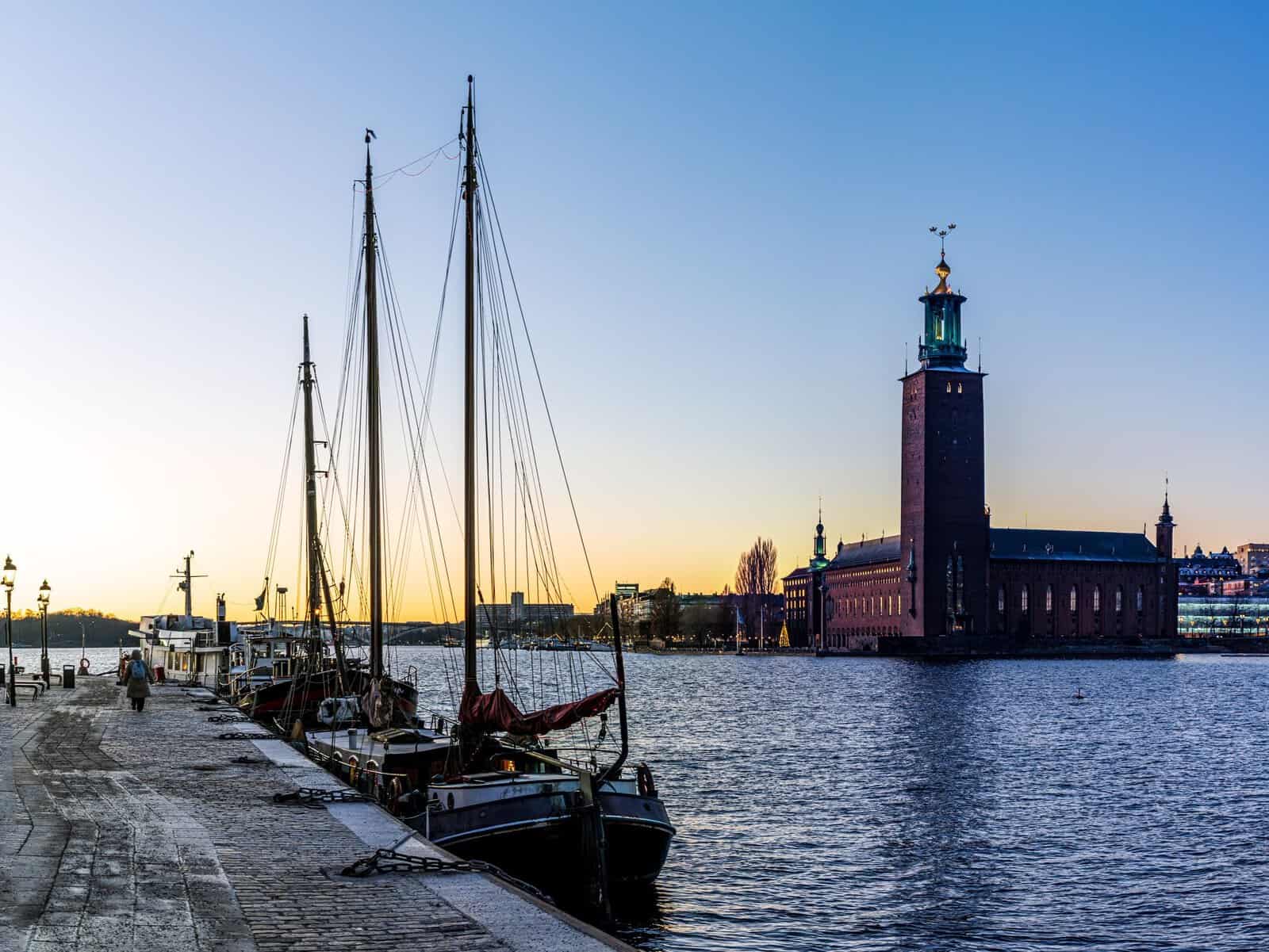Stockholm City Hall across the water with sailing boats