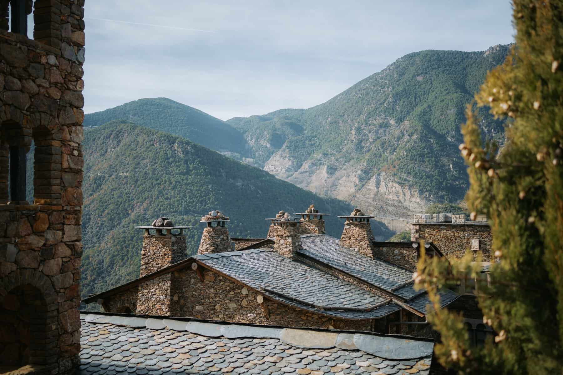 Stone houses with slate roofs beneath the mountains of Andorra