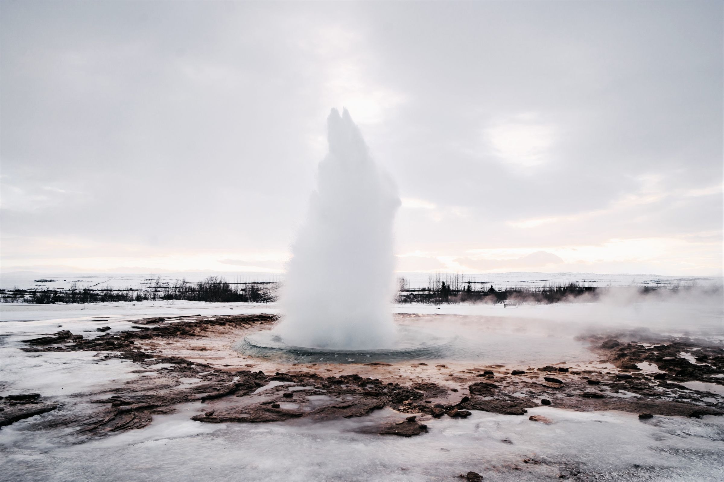 The Strokkur geyser erupting in winter