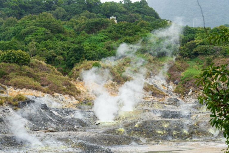Steaming sulphur springs in green hills