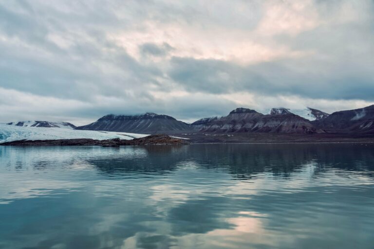 Arctic mountains reflected in calm water