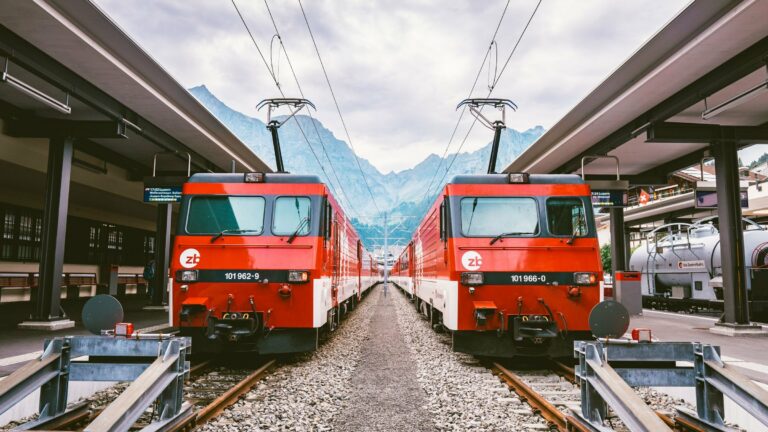 Red Swiss trains at a mountain station