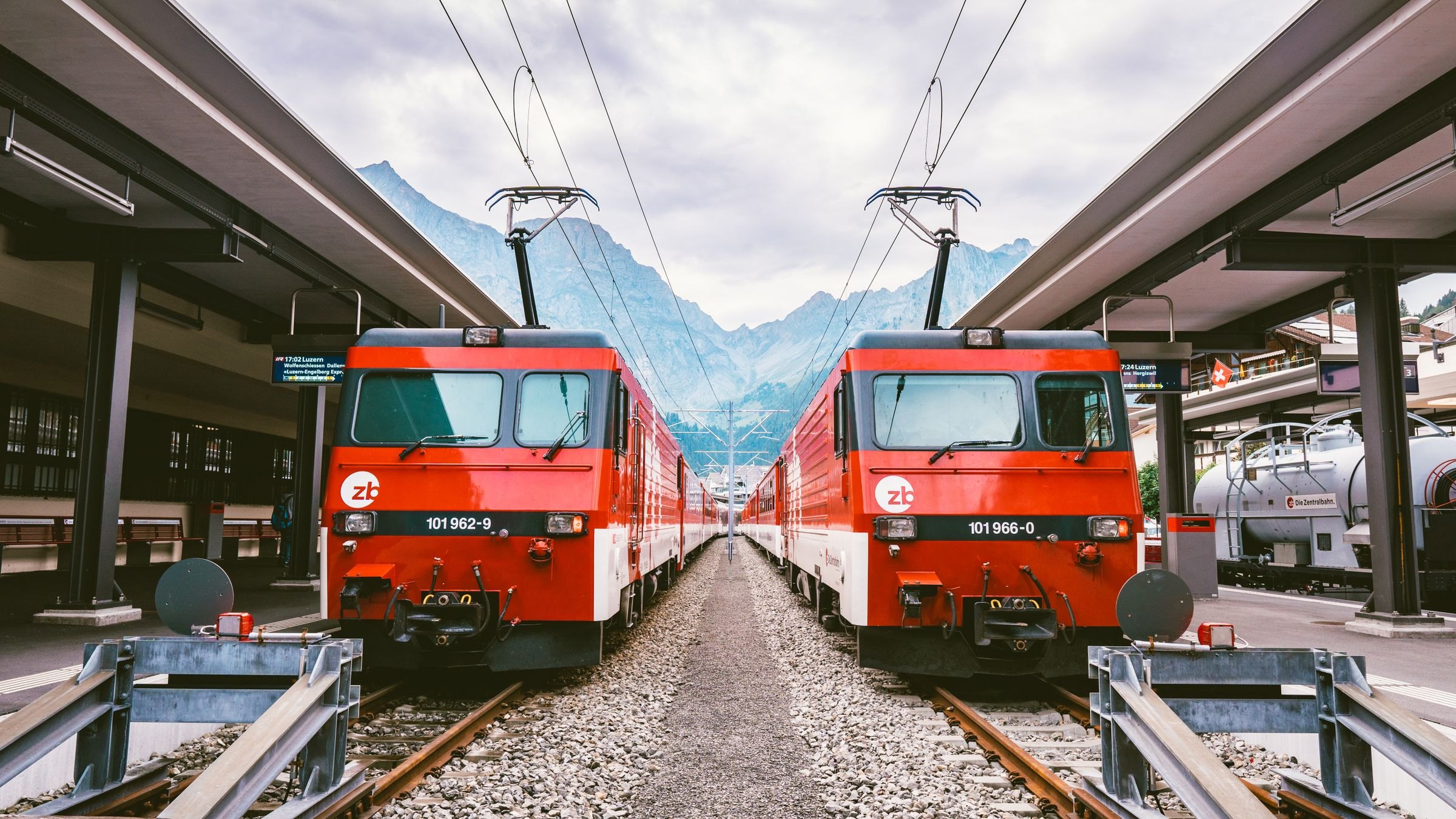 Red Swiss trains at a mountain station