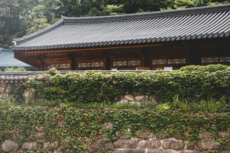 A Korean temple behind a stone wall