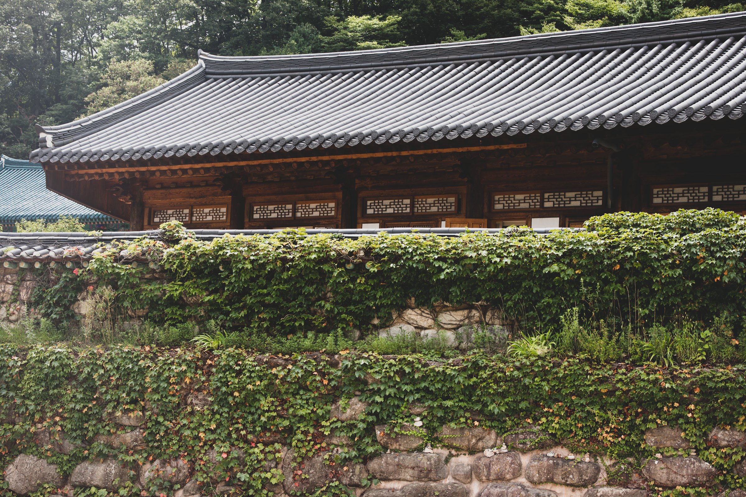 A Korean temple behind a stone wall