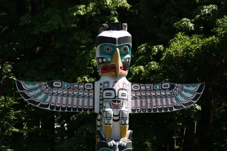 A carved totem pole in the forest