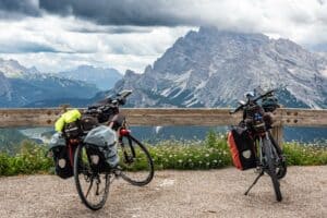 Touring bikes parked against Dolomite peaks