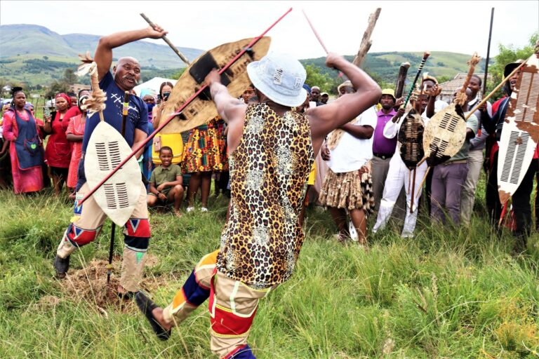 A traditional dance performance with shields