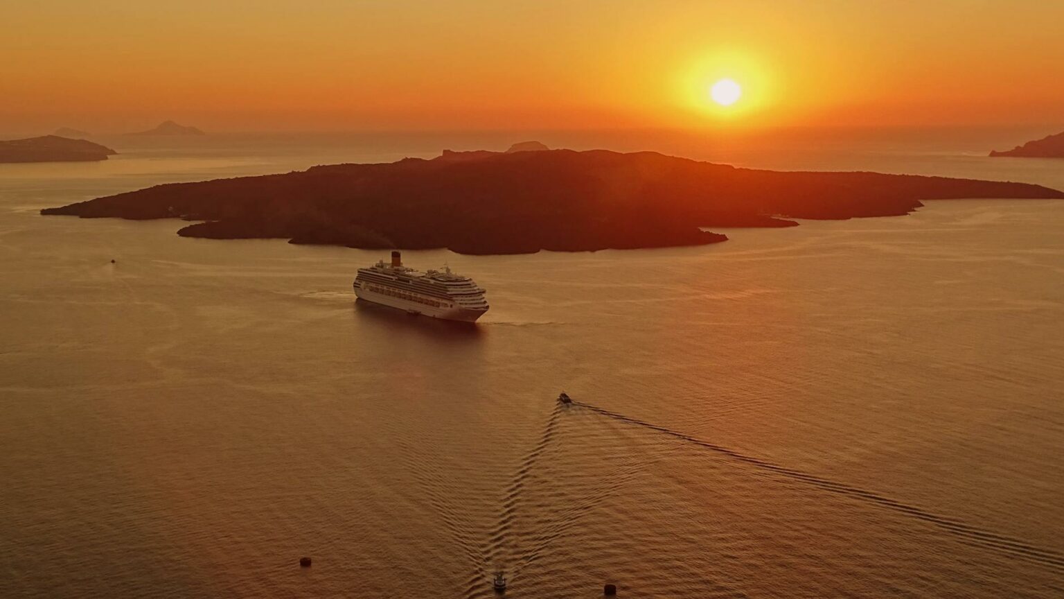 Cruises and expeditions chosen by Travelisto: a cruise ship off Santorini at sunset