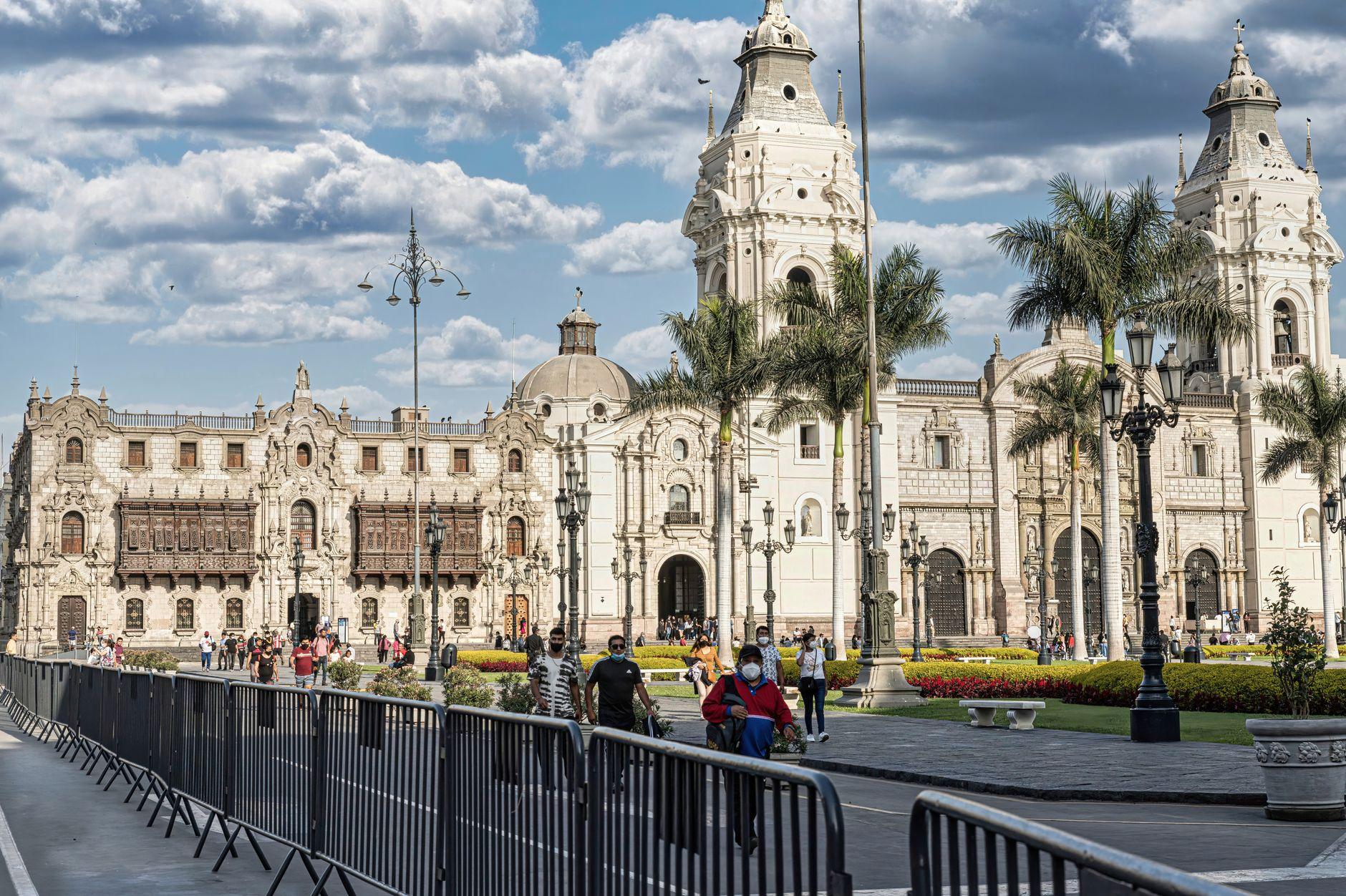 A bustling Plaza Mayor in Lima showcasing the historic Cathedral of Lima under blue s - Peru holidays by Travelisto.com