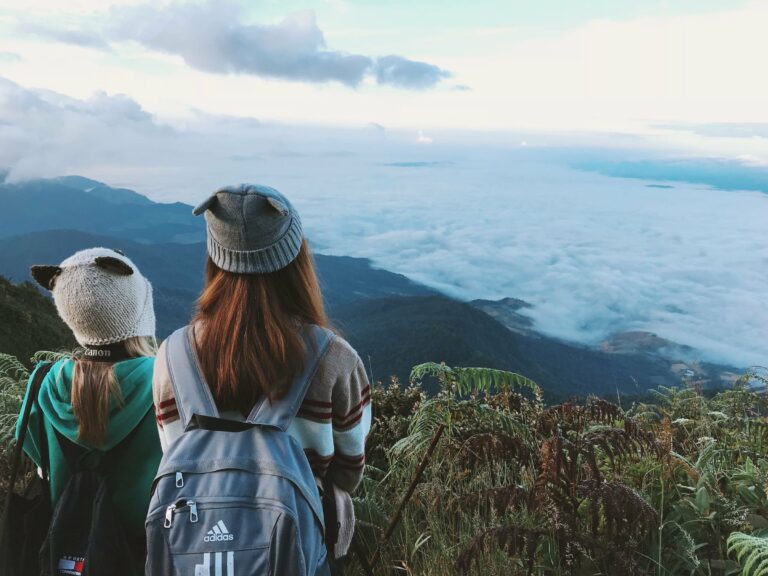 Trekkers looking out over misty mountains near Chiang Mai