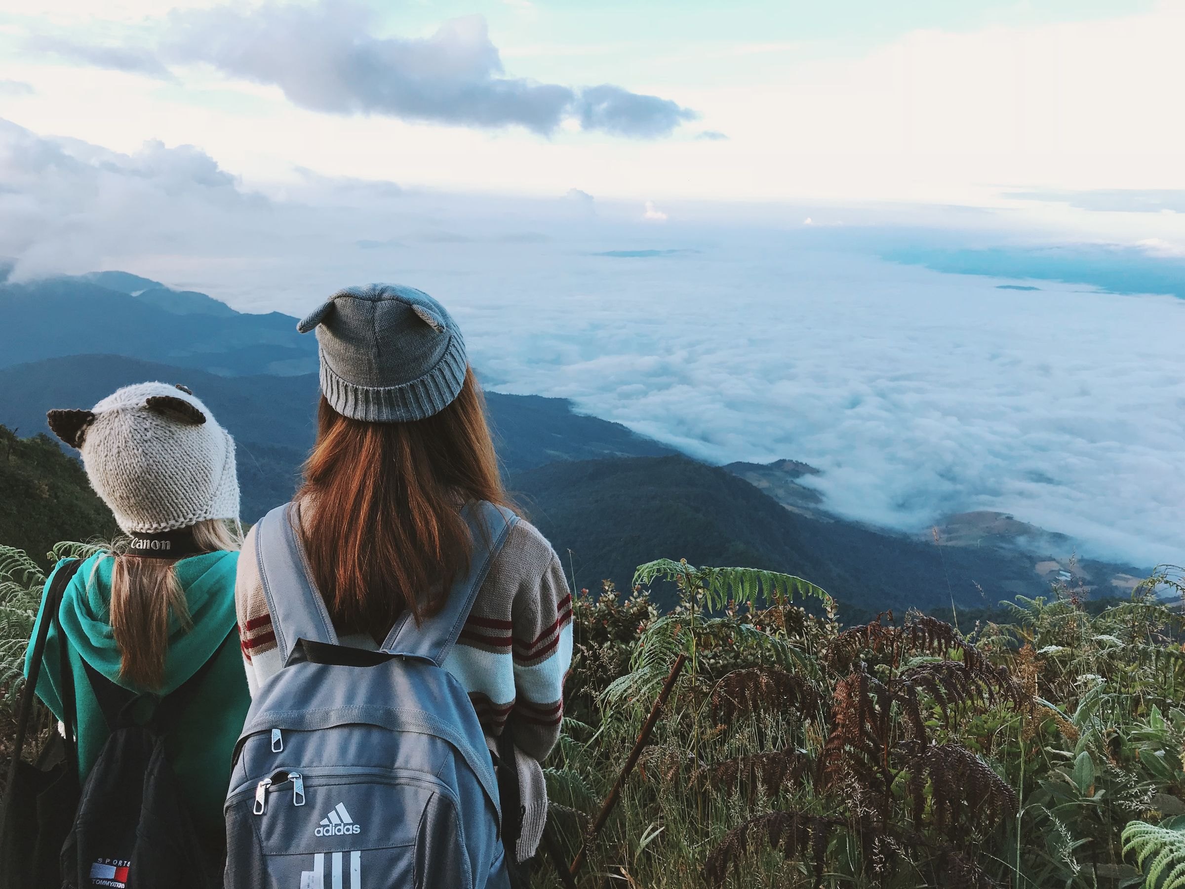 Trekkers looking out over misty mountains near Chiang Mai