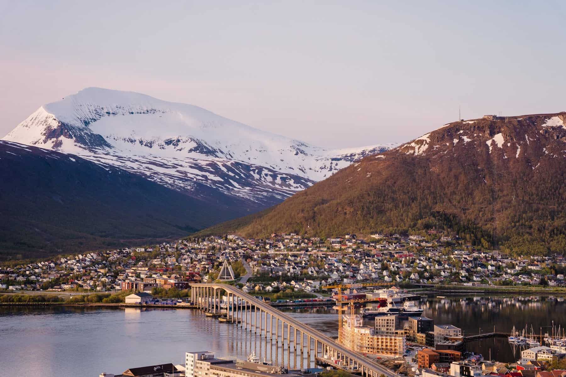 Tromsø and its bridge beneath snow-capped mountains, Norway