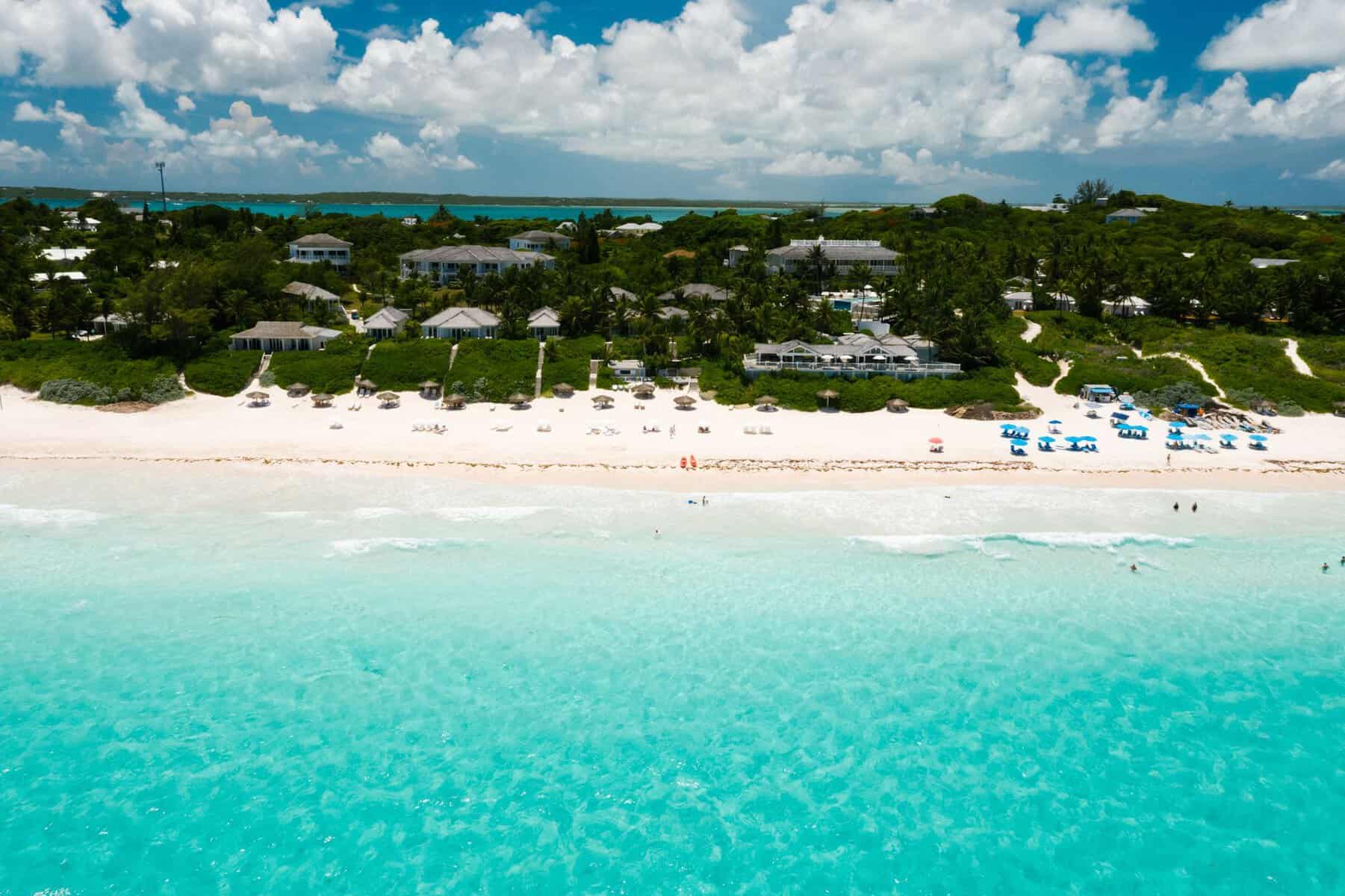 Aerial view of a tropical beach with turquoise water and white sand