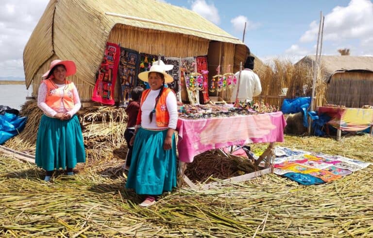 Women in traditional dress at a market on the Uros floating islands, Lake Titicaca