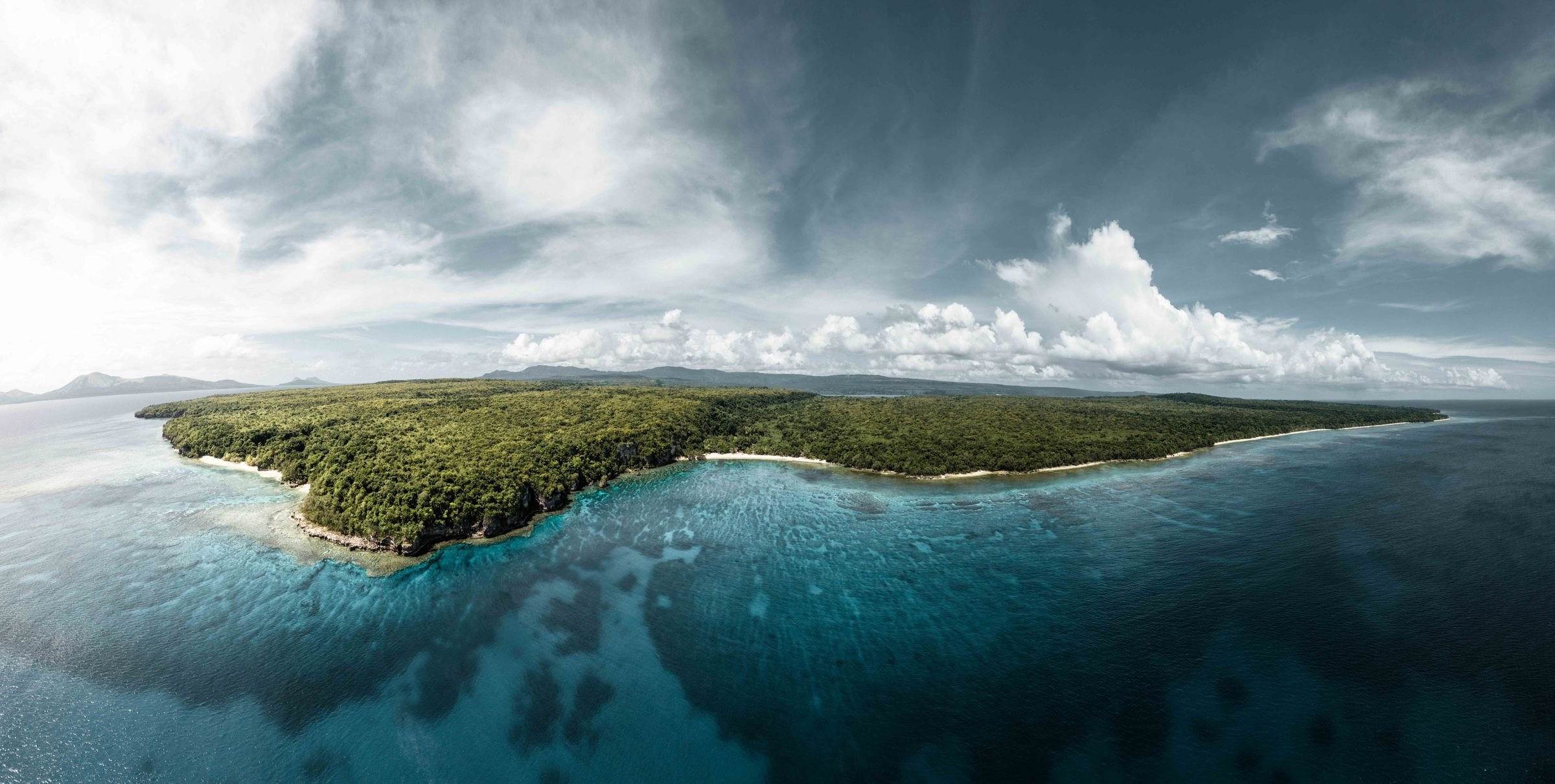 The lush green coastline of Vanuatu from above