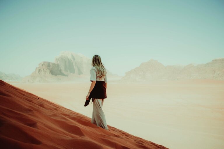 A walker on the red dunes of Wadi Rum
