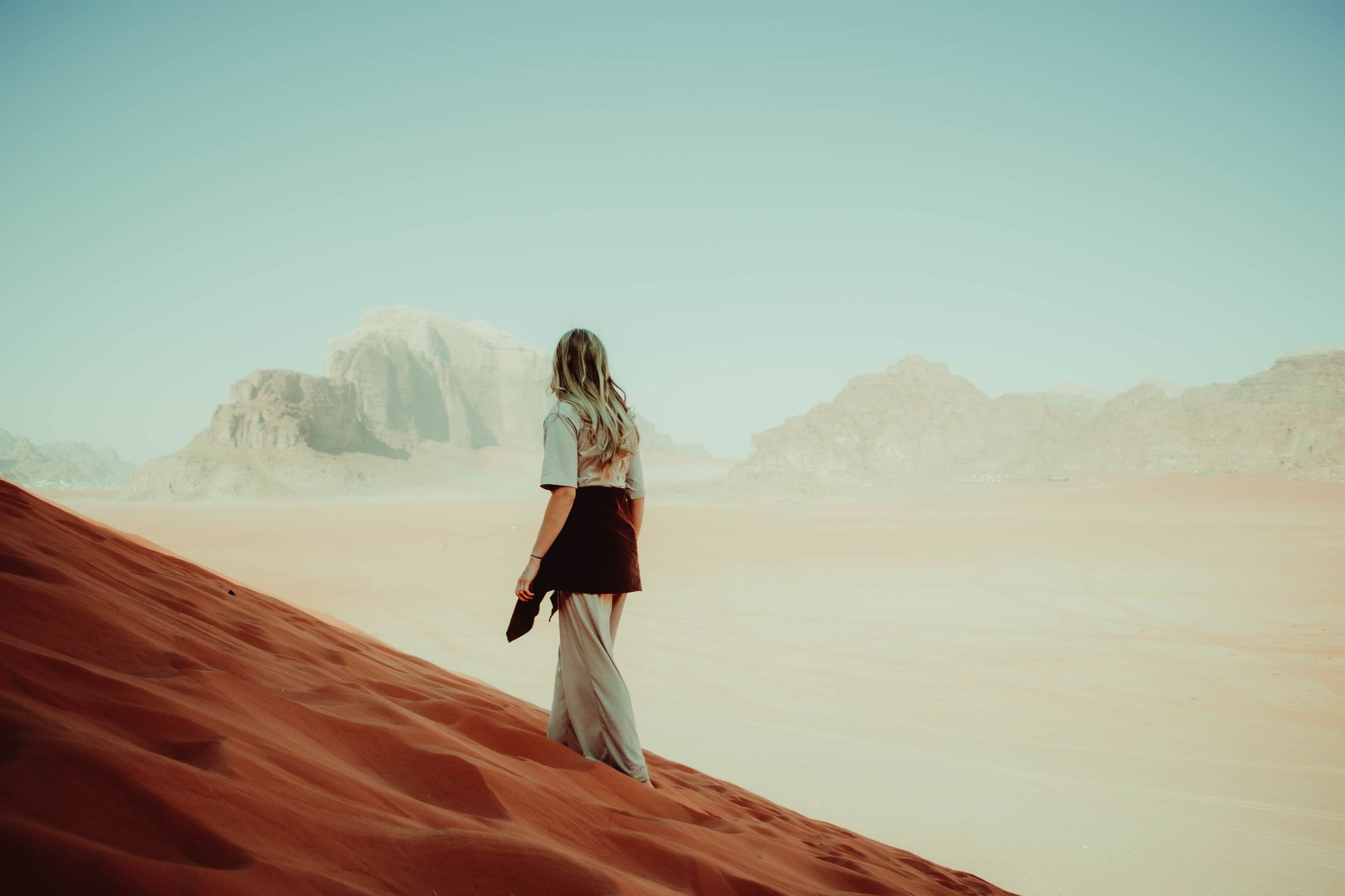 A walker on the red dunes of Wadi Rum