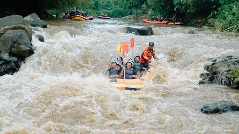 A group white-water rafting on a rocky river