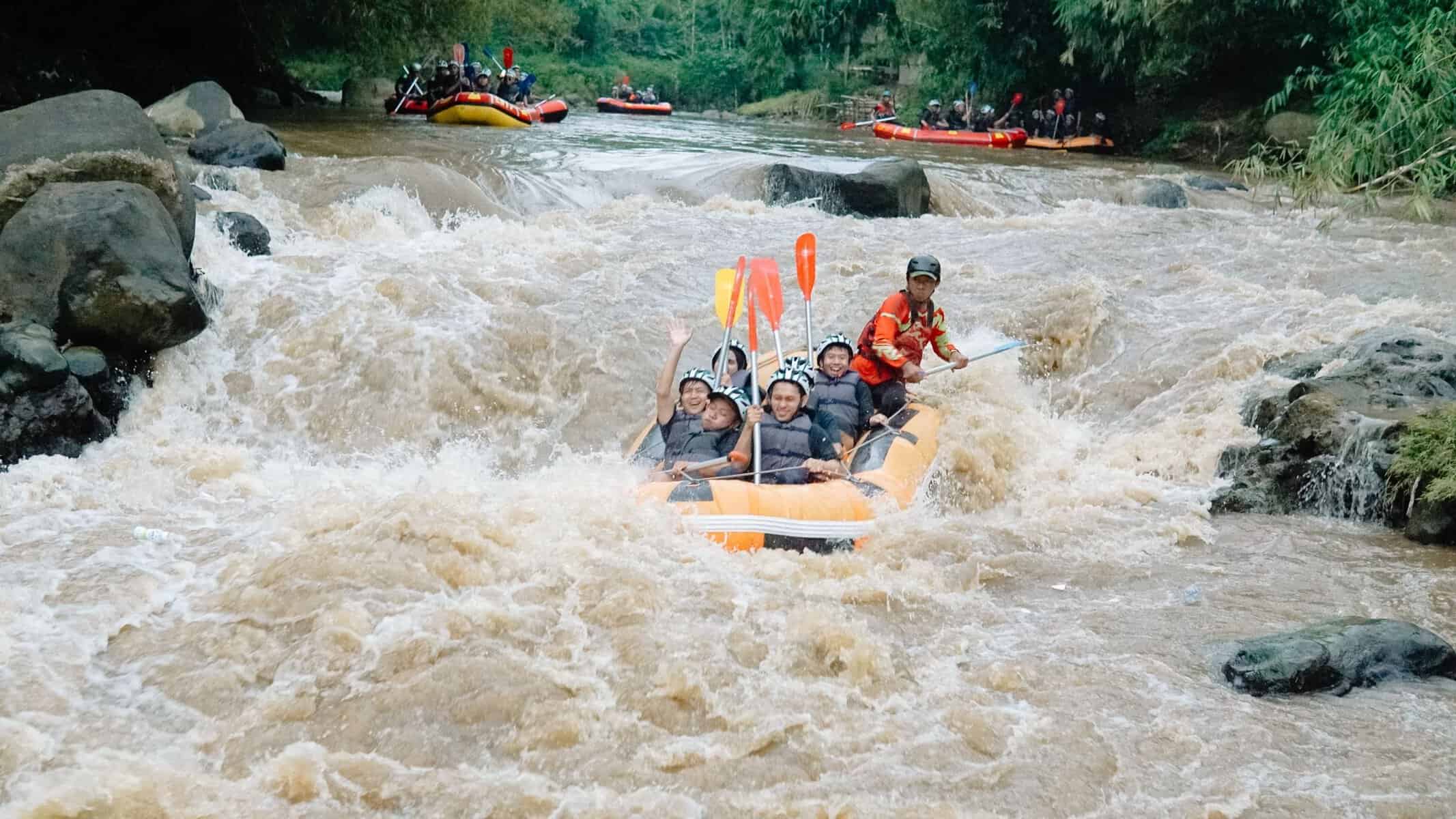A group white-water rafting on a rocky river